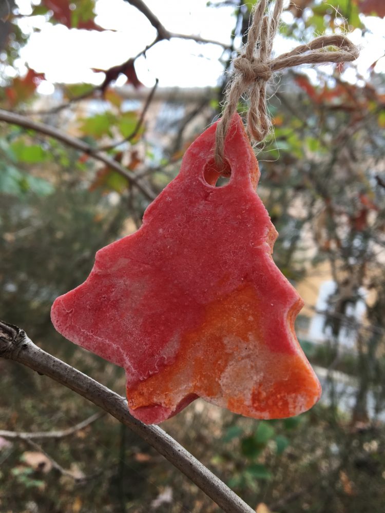 Cookie shaped like a pine tree with red and orange food coloring