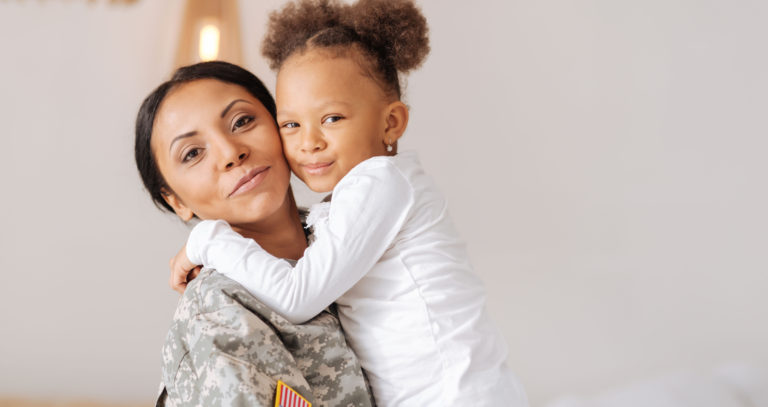 Mother in uniform with young daughter