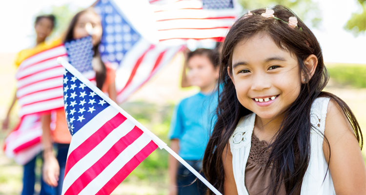 little girl holds American Flag