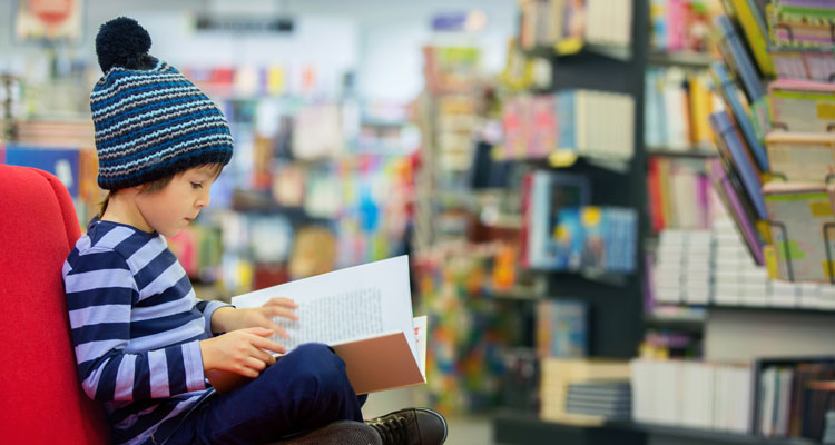 high IQ child reading in bookstore