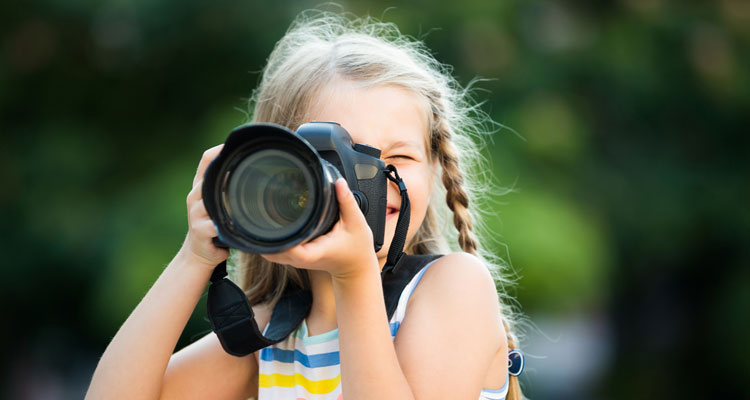 kid with camera taking nature photos