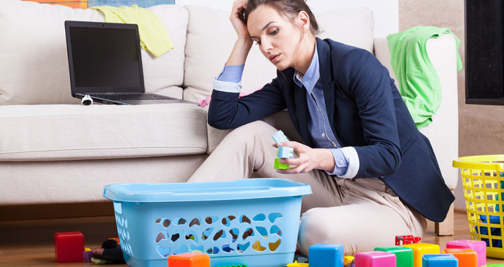 Stressed looking mother with toys on floor