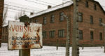 building in Auschwitz camp with old sign