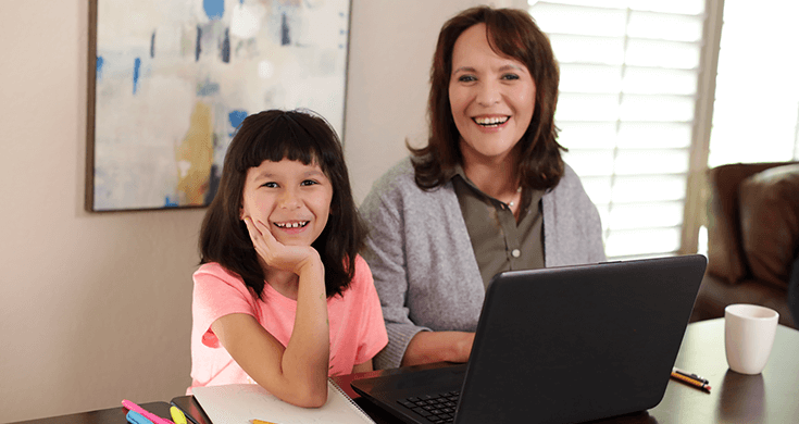 daughter and mom using laptop