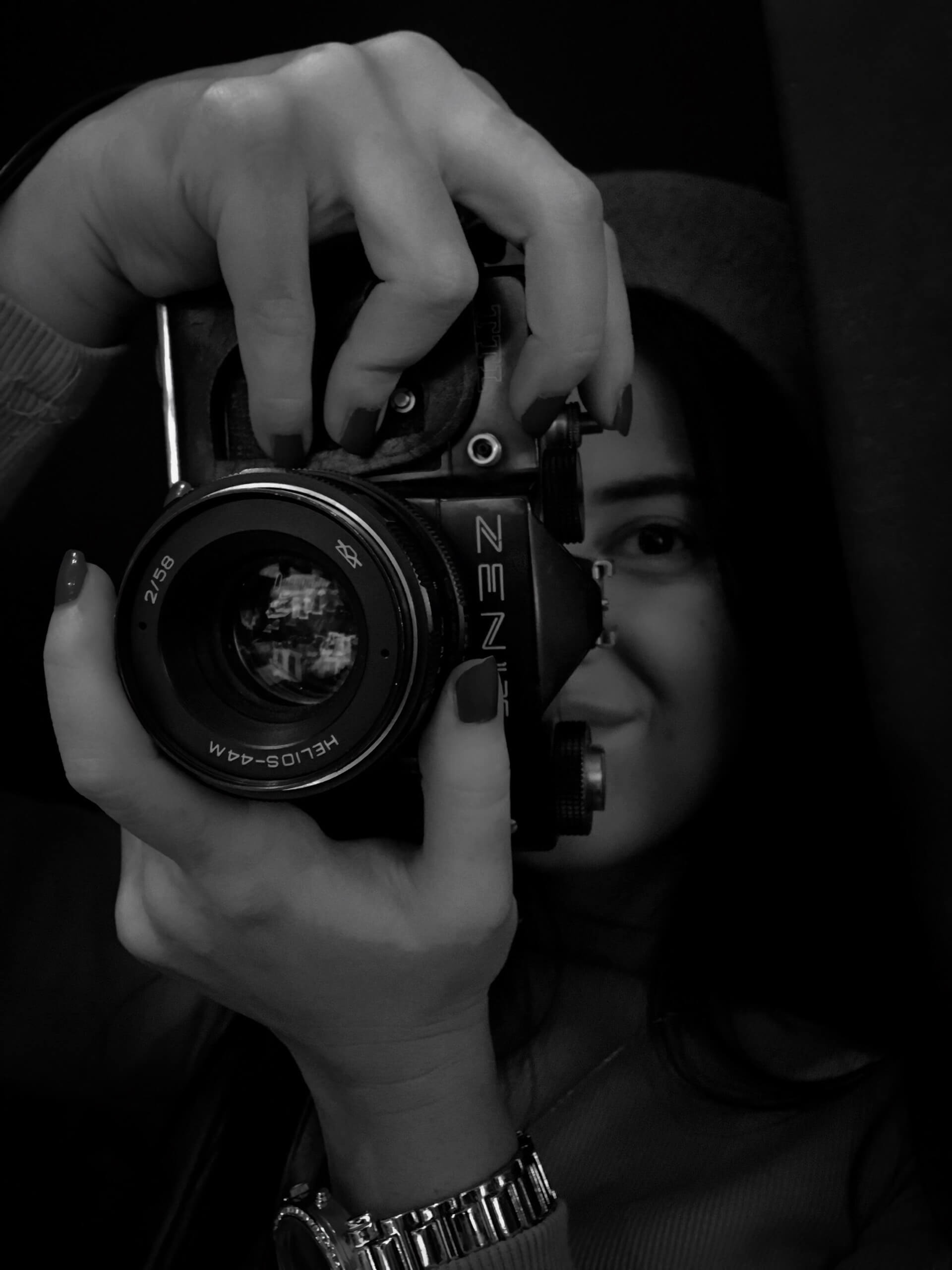 A girl looks into the lens of a camera