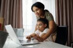 A mom helps her daughter with online school