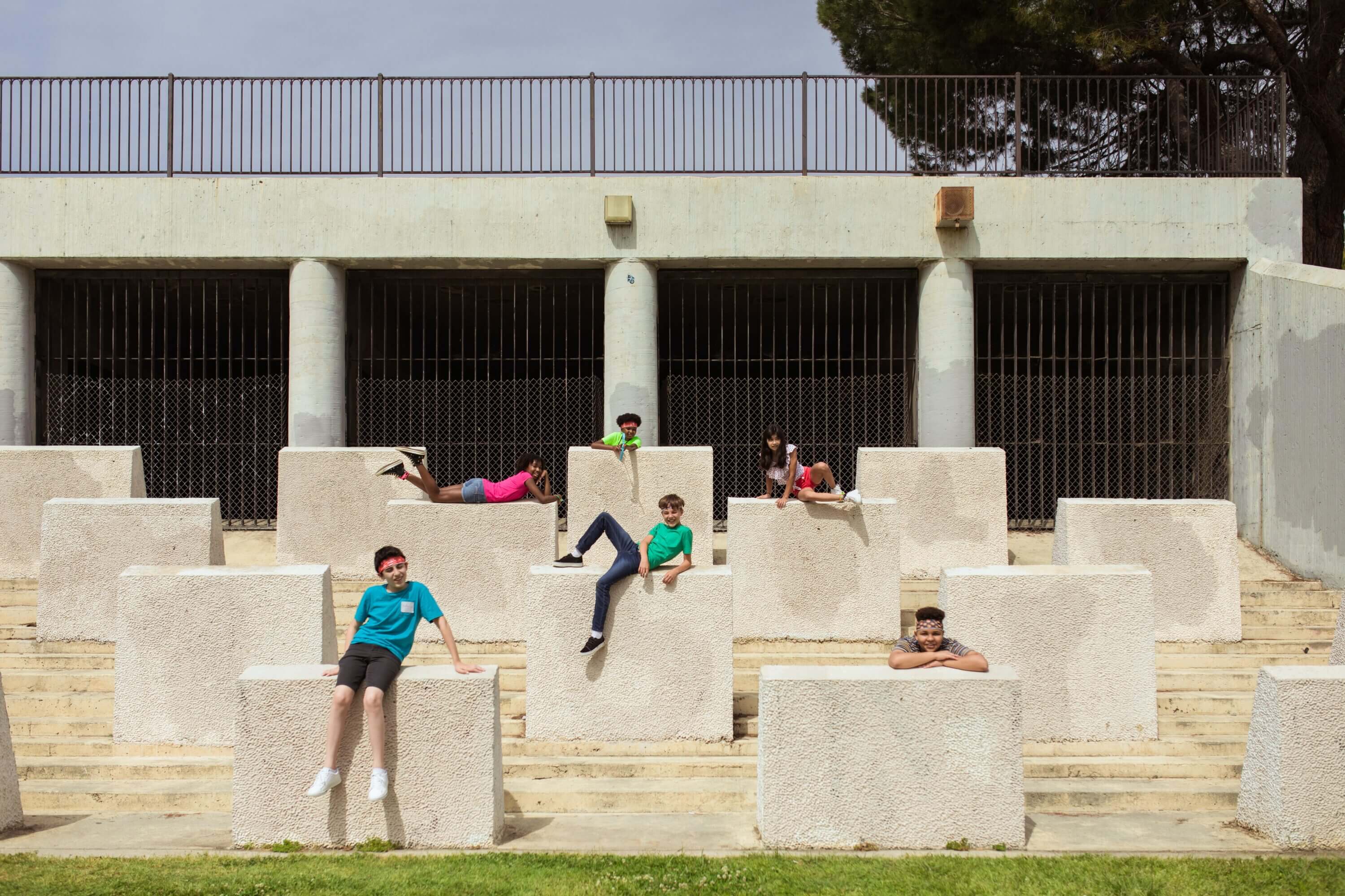 Students pose on large cement blocks while on a field trip