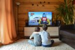 Two brothers watch fun YouTube videos together on their living room TV.