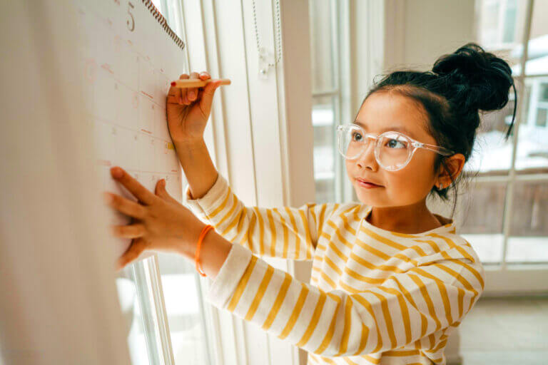 Girl writing on a whiteboard