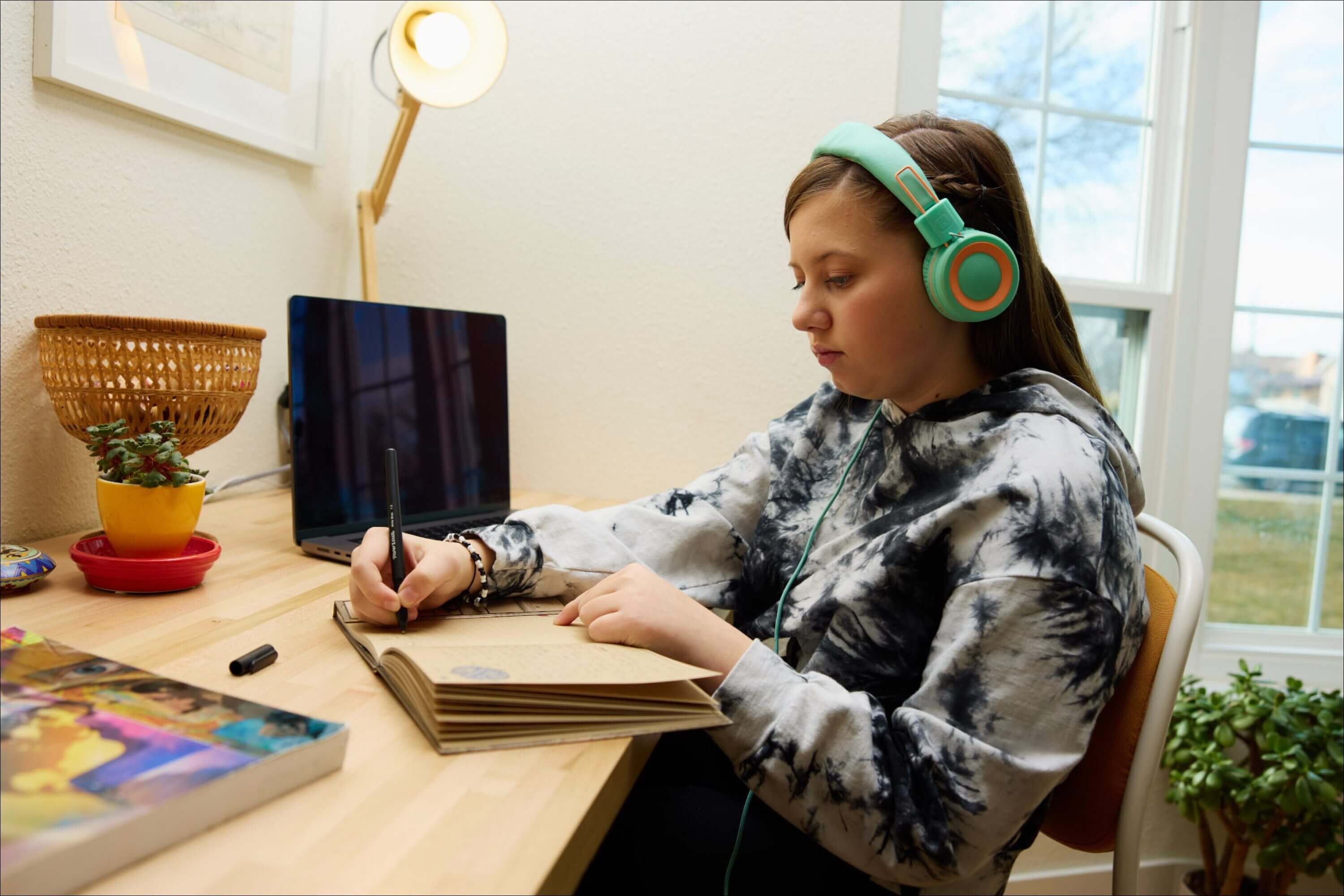 Student at laptop writing