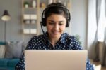 Student wearing headset on laptop