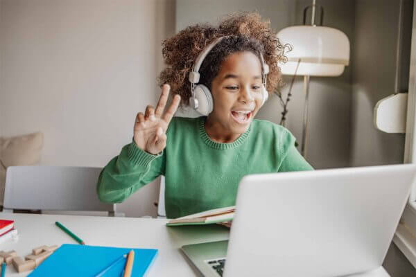 Student using headphones and laptop