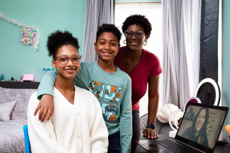 Mother and her children attending to an online class