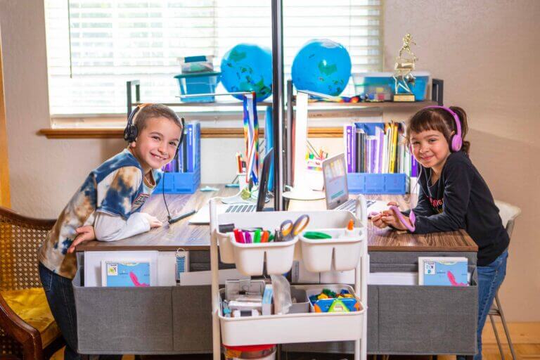 Elementary student working at their desks while wearing headphones