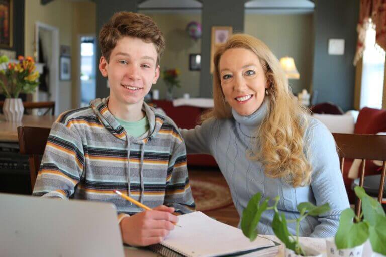 Mother and son taking notes at home